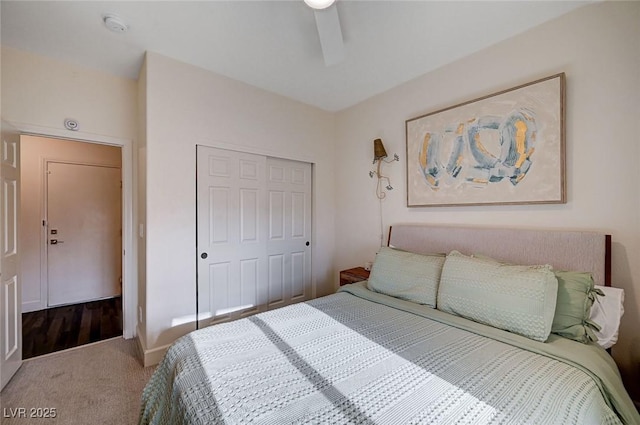 carpeted bedroom with a ceiling fan and a closet