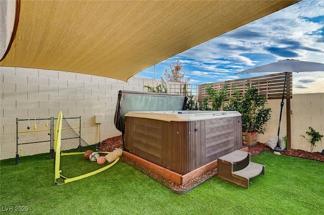 view of yard featuring a fenced backyard and a hot tub
