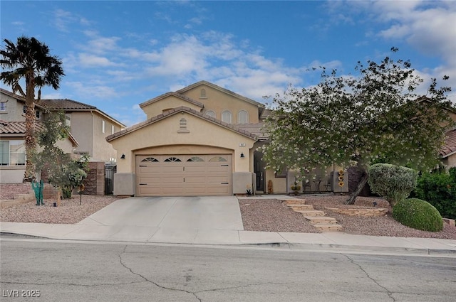 view of front of house featuring concrete driveway, a tiled roof, a garage, and stucco siding