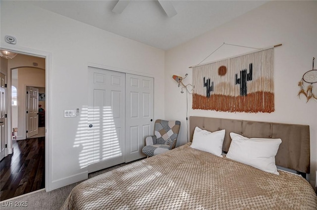 bedroom featuring a closet, baseboards, and ceiling fan