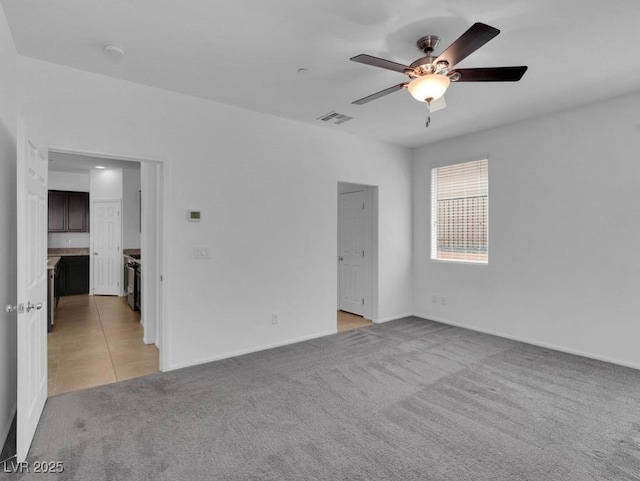 1063 Upper Springs St, Henderson, NV 89002 - empty room featuring light carpet, ceiling fan, and baseboards