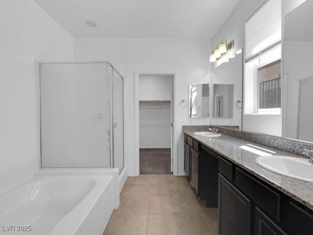 1063 Upper Springs St, Henderson, NV 89002 - full bathroom featuring a stall shower, a bath, a spacious closet, double vanity, and tile patterned flooring