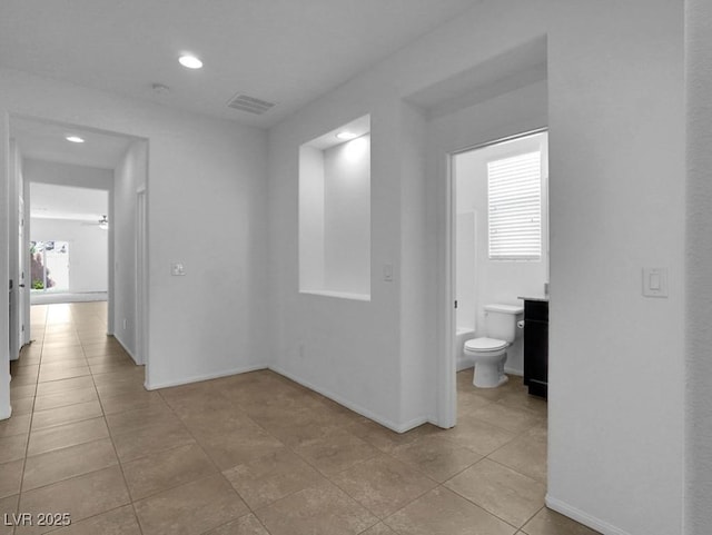 1063 Upper Springs St, Henderson, NV 89002 - corridor with light tile patterned floors, recessed lighting, and baseboards