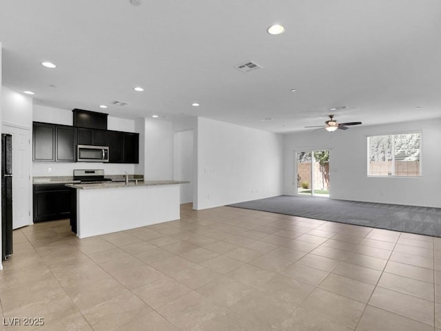 1063 Upper Springs St, Henderson, NV 89002 - unfurnished living room featuring recessed lighting, light tile patterned floors, ceiling fan, and a sink