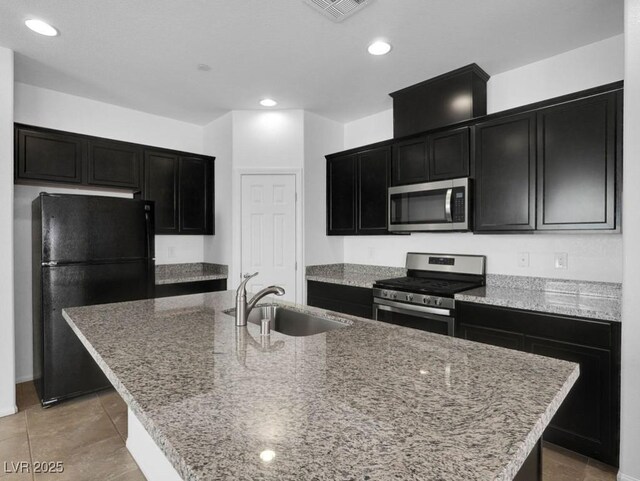 1063 Upper Springs St, Henderson, NV 89002 - kitchen featuring stainless steel appliances, a sink, dark cabinets, an island with sink, and recessed lighting