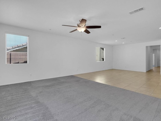 1063 Upper Springs St, Henderson, NV 89002 - empty room featuring ceiling fan, light colored carpet, recessed lighting, and light tile patterned flooring
