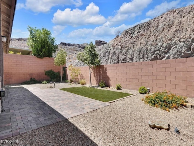 1063 Upper Springs St, Henderson, NV 89002 - fenced backyard featuring a mountain view and a patio area