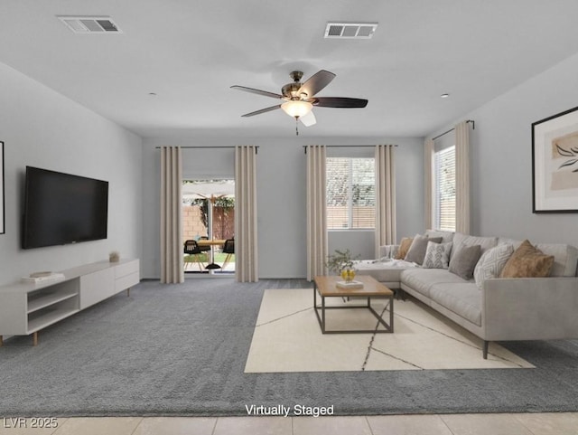 1063 Upper Springs St, Henderson, NV 89002 - tiled living room with ceiling fan and carpet floors