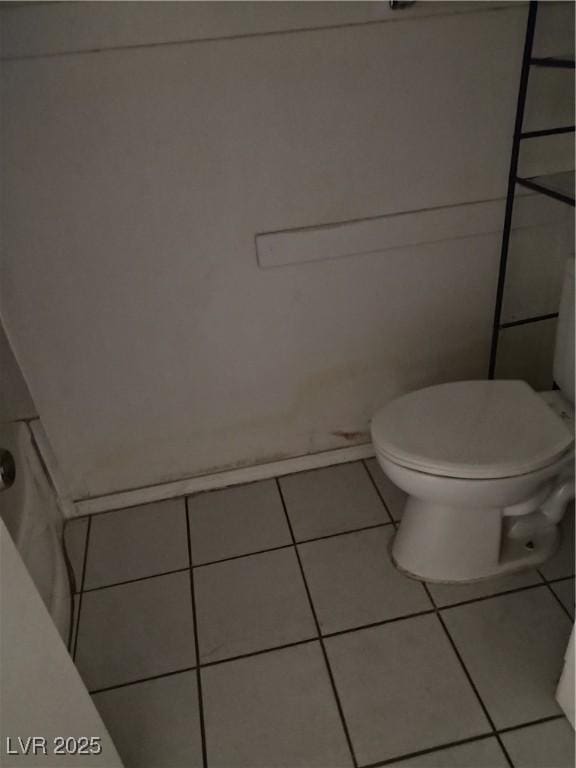 bathroom with tile patterned flooring and toilet