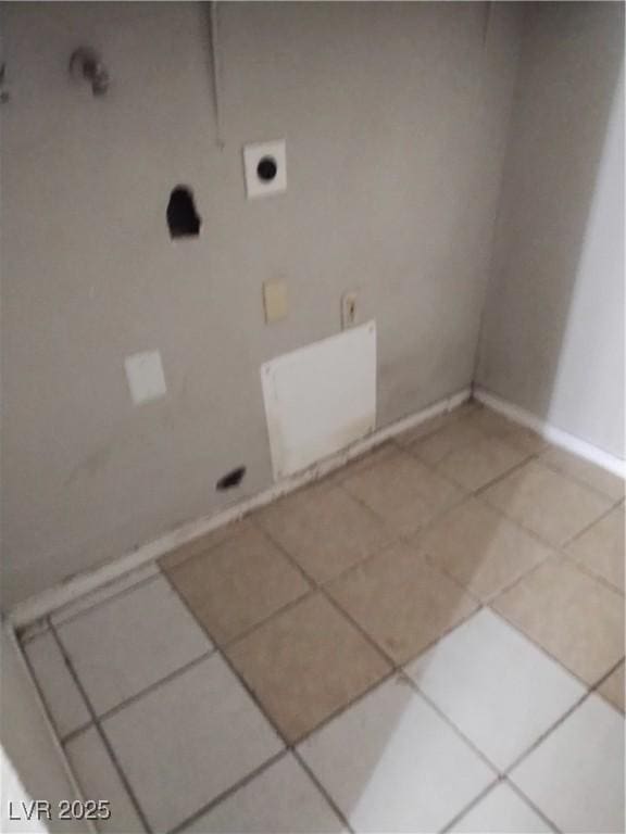 laundry room featuring baseboards, tile patterned floors, laundry area, and electric dryer hookup