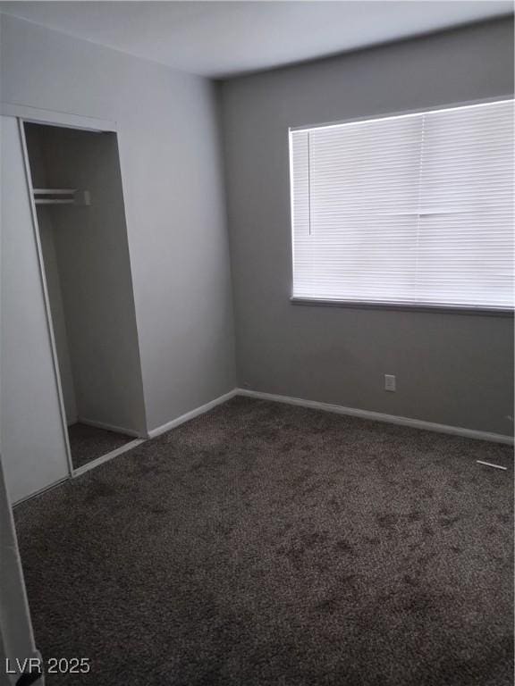 unfurnished bedroom featuring carpet floors and a closet