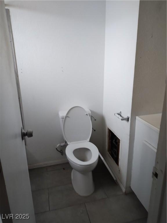 bathroom featuring tile patterned flooring and toilet