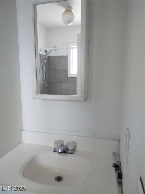 bathroom with a shower and a sink
