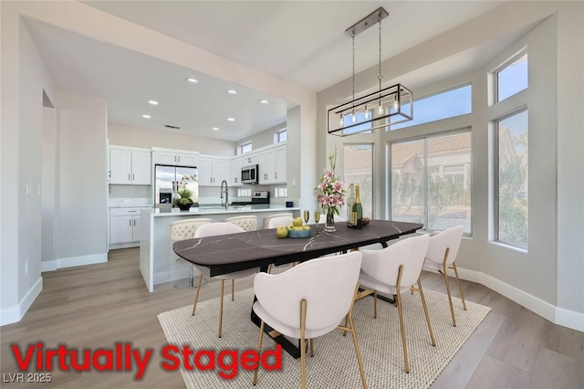 dining room featuring visible vents, baseboards, light wood finished floors, an inviting chandelier, and recessed lighting
