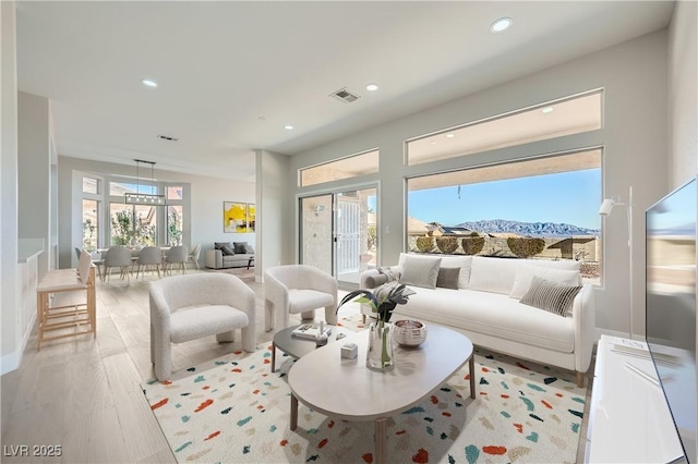 living area featuring visible vents, recessed lighting, and light wood-type flooring