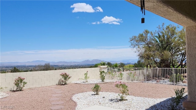 view of yard with a fenced backyard and a mountain view
