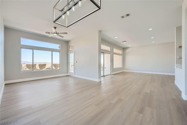 unfurnished living room featuring a ceiling fan, visible vents, light wood-type flooring, baseboards, and recessed lighting