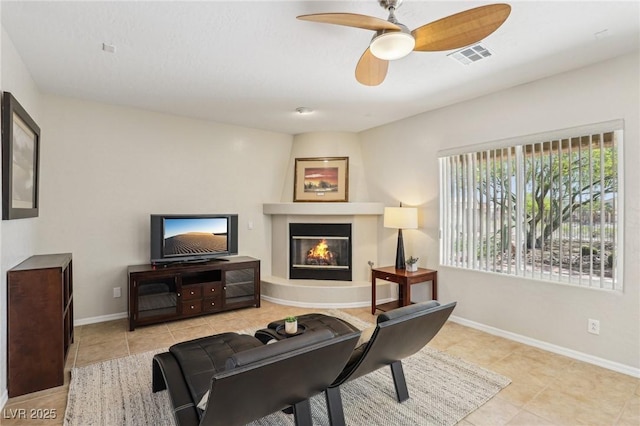 8316 Imperial Lakes St, Las Vegas, NV 89131 - tiled living area with a glass covered fireplace, ceiling fan, and baseboards