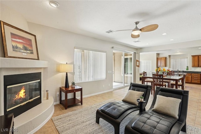 8316 Imperial Lakes St, Las Vegas, NV 89131 - living area with light tile patterned floors, ceiling fan, a glass covered fireplace, baseboards, and recessed lighting