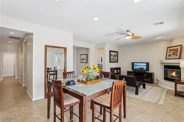 8316 Imperial Lakes St, Las Vegas, NV 89131 - dining room featuring light tile patterned flooring, a ceiling fan, a glass covered fireplace, recessed lighting, and baseboards