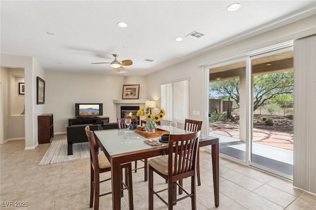 8316 Imperial Lakes St, Las Vegas, NV 89131 - dining space featuring a ceiling fan, light tile patterned floors, a glass covered fireplace, recessed lighting, and baseboards