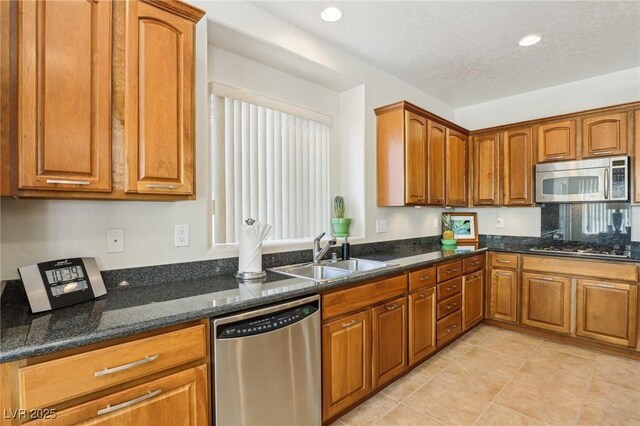 8316 Imperial Lakes St, Las Vegas, NV 89131 - kitchen featuring appliances with stainless steel finishes, a sink, brown cabinetry, and recessed lighting