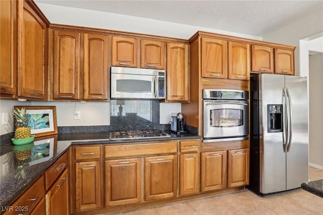 8316 Imperial Lakes St, Las Vegas, NV 89131 - kitchen with stainless steel appliances and brown cabinetry
