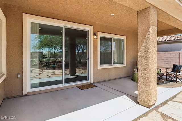 8316 Imperial Lakes St, Las Vegas, NV 89131 - view of exterior entry featuring a patio and stucco siding