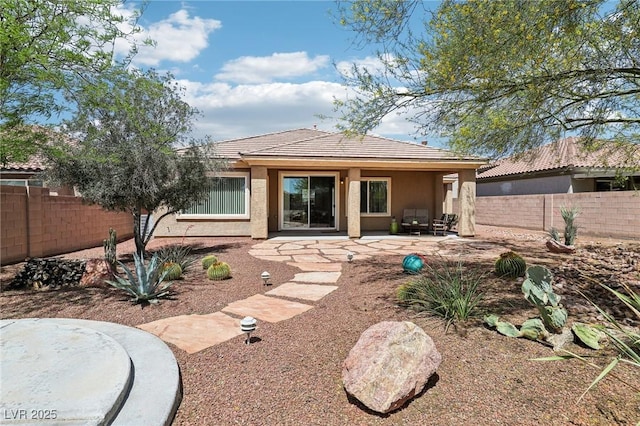 8316 Imperial Lakes St, Las Vegas, NV 89131 - back of house featuring a tile roof, a fenced backyard, stucco siding, and a patio