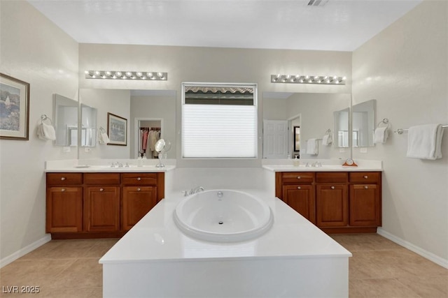 8316 Imperial Lakes St, Las Vegas, NV 89131 - full bath featuring a bath, two vanities, tile patterned floors, and baseboards