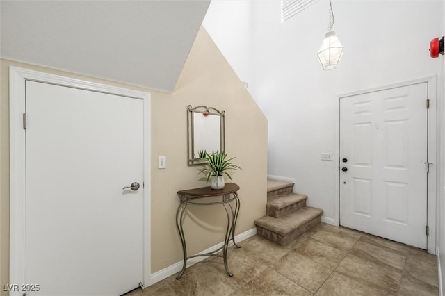 entrance foyer with baseboards and stairs