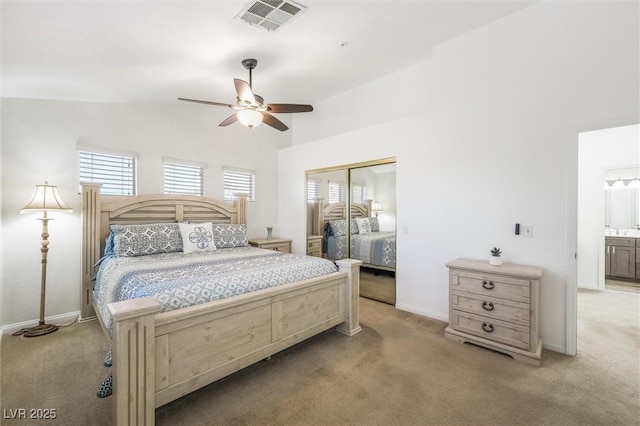 bedroom featuring visible vents, multiple windows, and light colored carpet