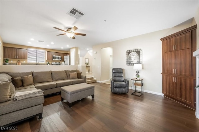 living area featuring baseboards, ceiling fan, dark wood-type flooring, and visible vents