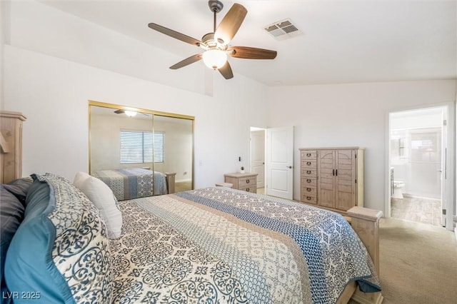 bedroom featuring ceiling fan, carpet, lofted ceiling, visible vents, and a closet