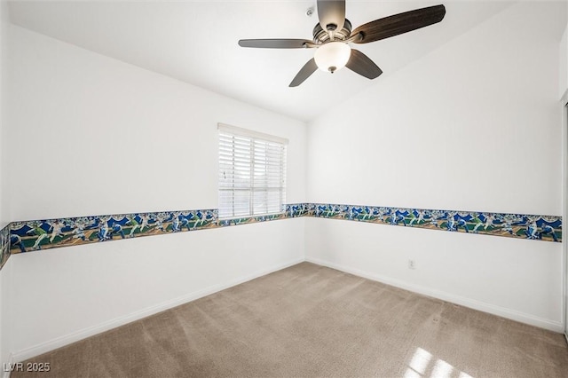 carpeted empty room with baseboards, ceiling fan, and lofted ceiling