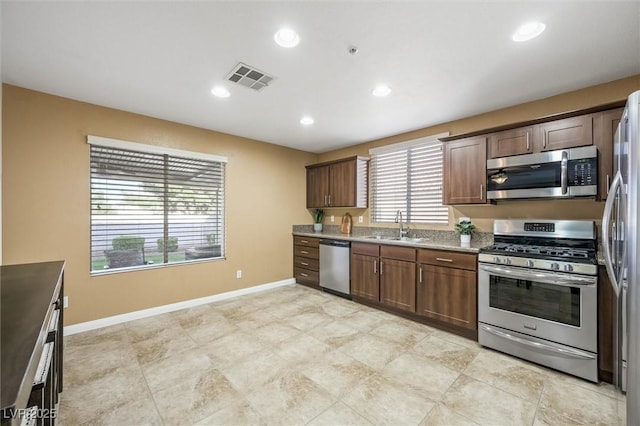 kitchen featuring visible vents, baseboards, recessed lighting, a sink, and appliances with stainless steel finishes