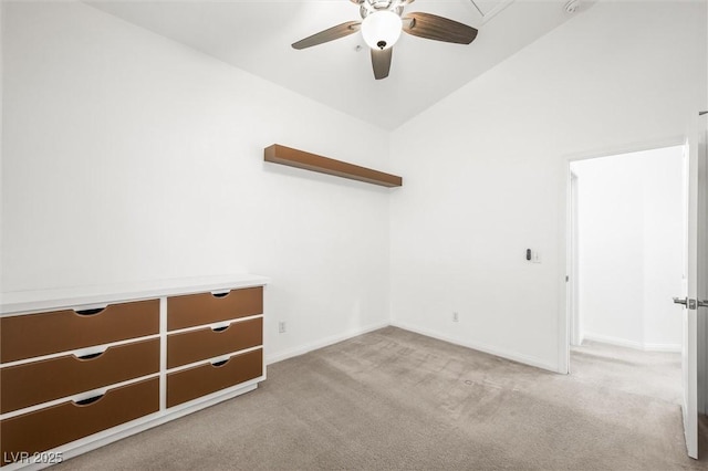 unfurnished room with carpet floors, baseboards, a ceiling fan, and lofted ceiling