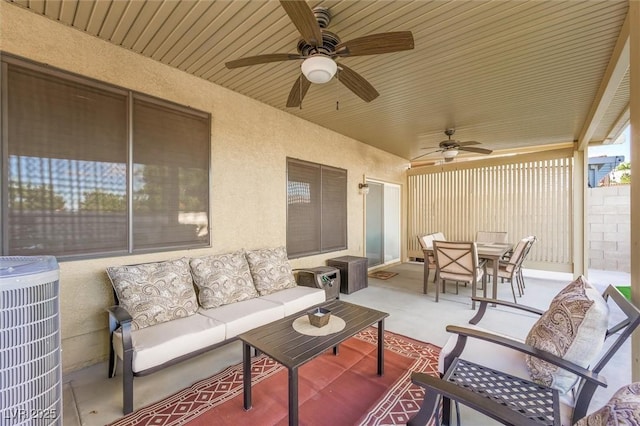 view of patio / terrace featuring central air condition unit, ceiling fan, an outdoor living space, and outdoor dining space