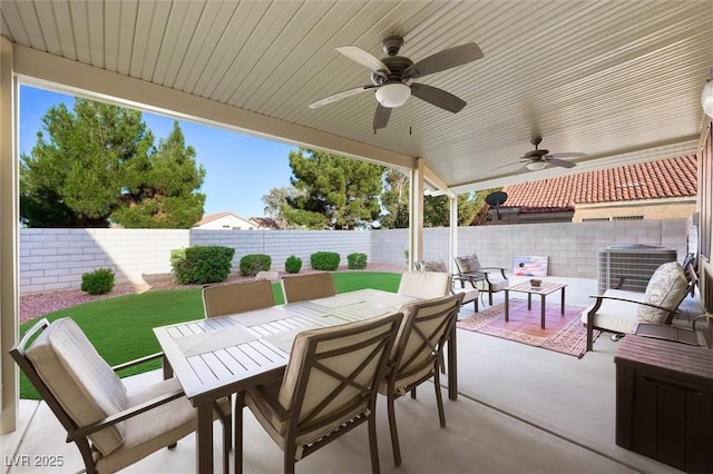 view of patio / terrace featuring a fenced backyard, outdoor dining space, ceiling fan, and outdoor lounge area
