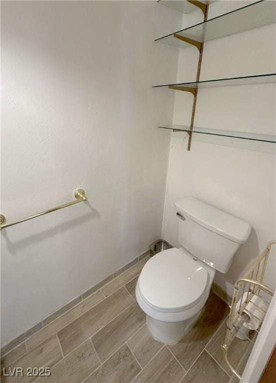 bathroom with wood finish floors and toilet