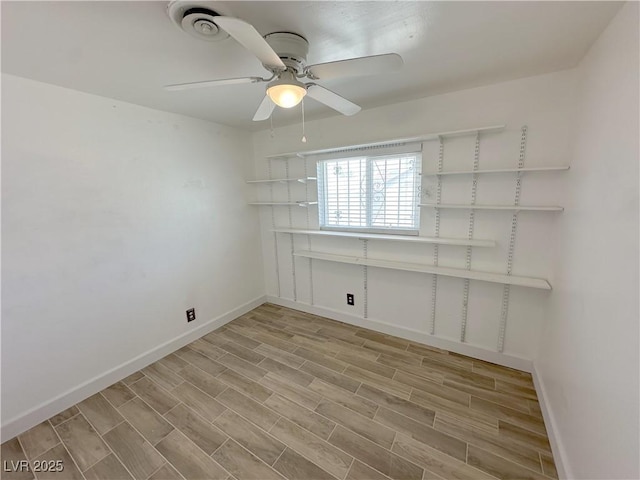 empty room featuring baseboards, ceiling fan, and light wood-style floors