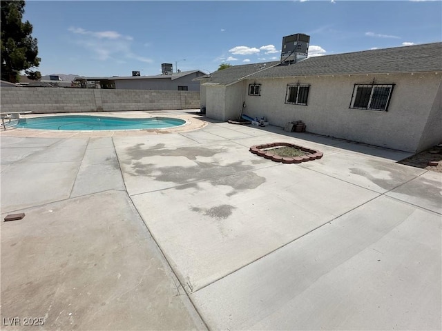 view of swimming pool featuring a patio, a fenced backyard, a fenced in pool, and cooling unit