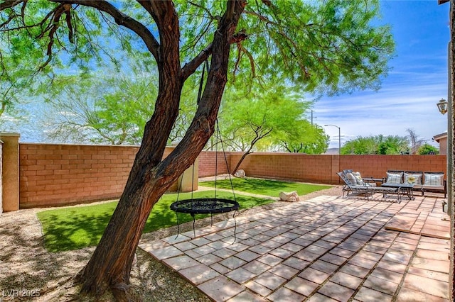 view of patio featuring outdoor lounge area and a fenced backyard