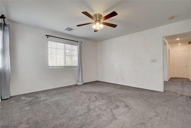 carpeted empty room with visible vents, a ceiling fan, and baseboards