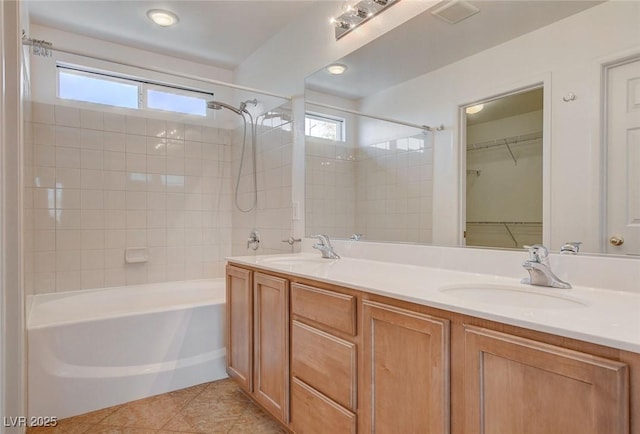 full bathroom featuring double vanity, a sink, bathtub / shower combination, and a wealth of natural light