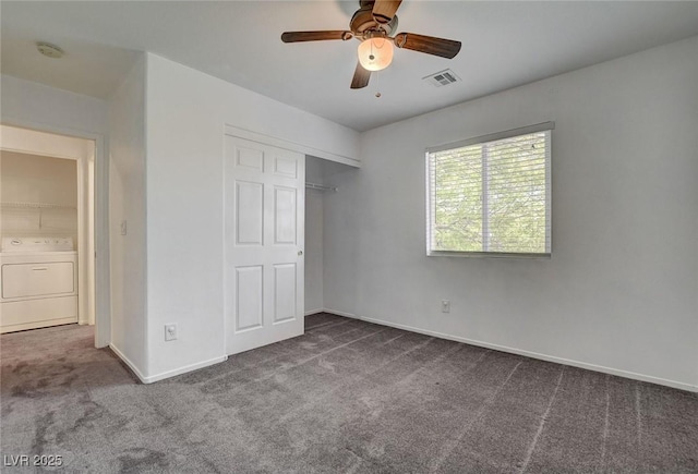 unfurnished bedroom featuring visible vents, a closet, washer / dryer, baseboards, and carpet flooring