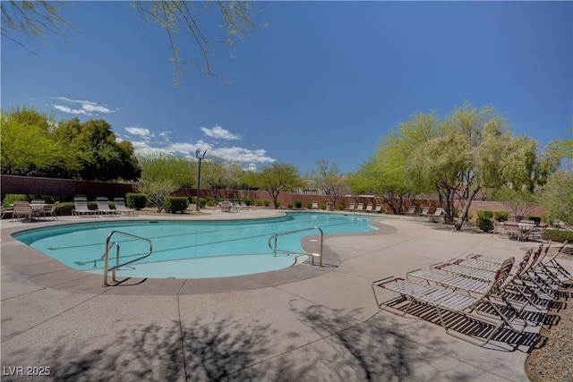 pool featuring fence and a patio area