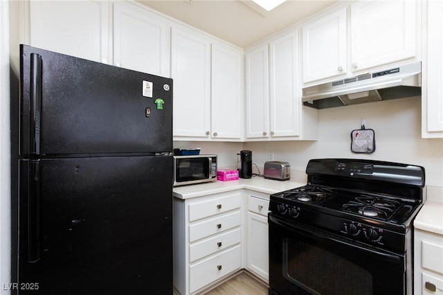 kitchen with white cabinetry, black appliances, light countertops, and under cabinet range hood