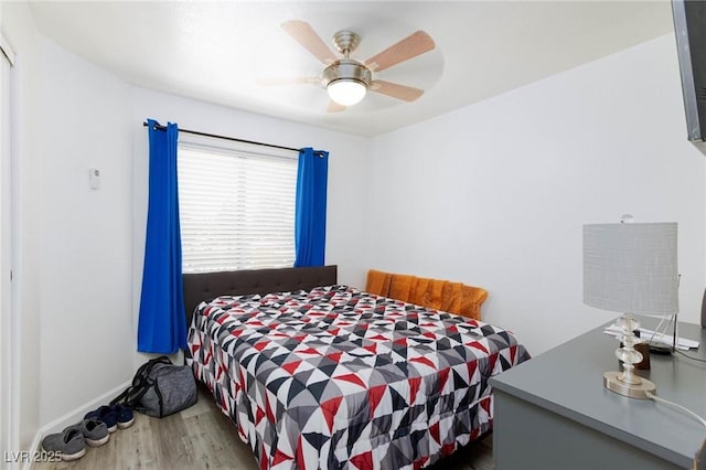 bedroom featuring baseboards, ceiling fan, and wood finished floors