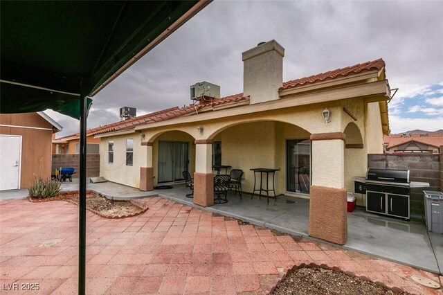 2595 Fort Lauderdale Dr, Las Vegas, NV 89156 - back of property featuring a patio area, a chimney, stucco siding, and fence